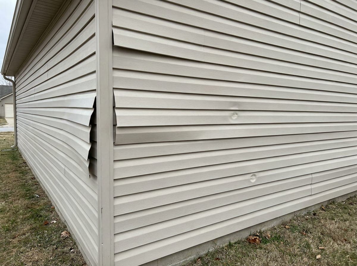 Damaged siding before repair